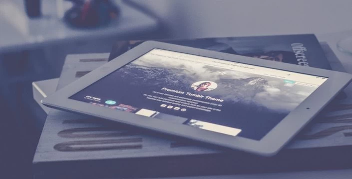 An ipad sitting on top of a book.