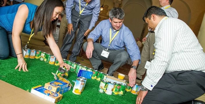 A group of people playing a game on the grass.