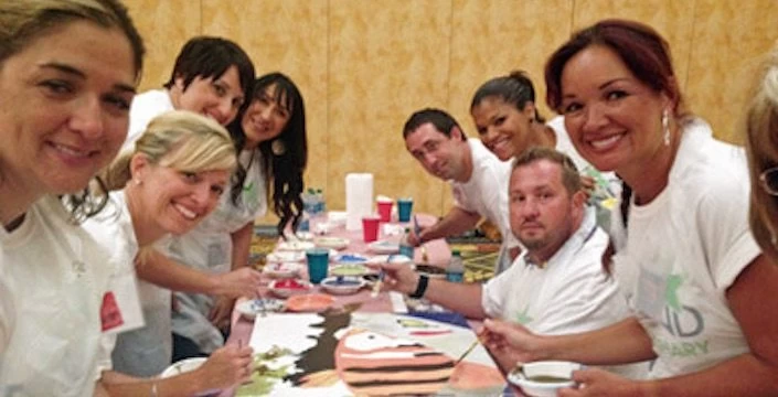 A group of people posing for a picture at a table.