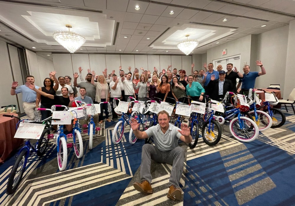 A group of people posing for a photo with their bicycles.