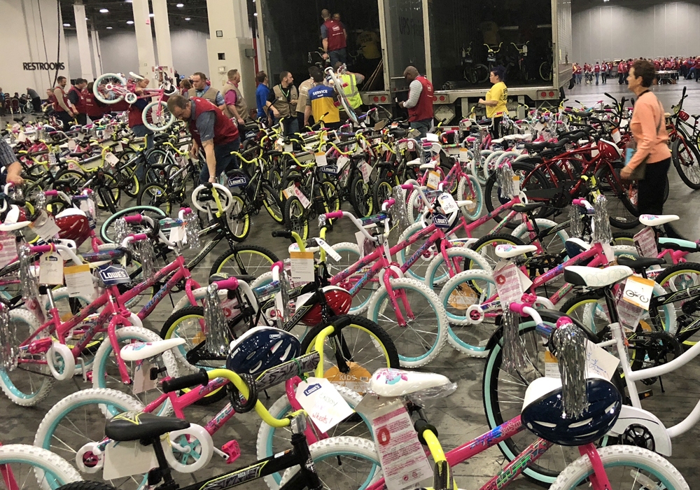 A room full of bicycles in a convention center.