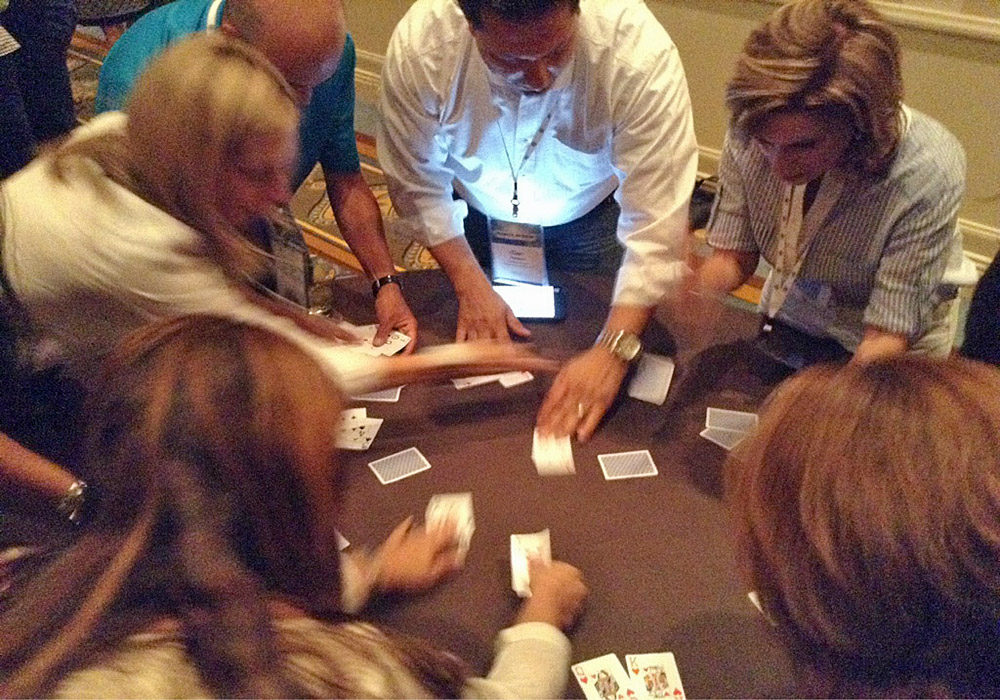 A group of people playing a game of cards.