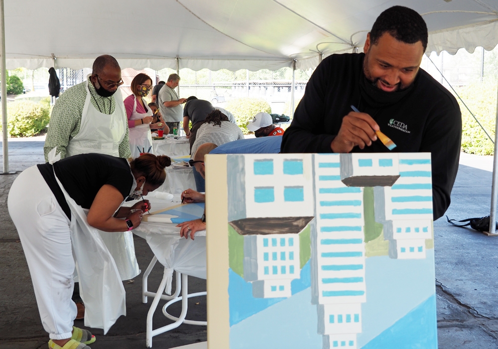 A man painting on a canvas.