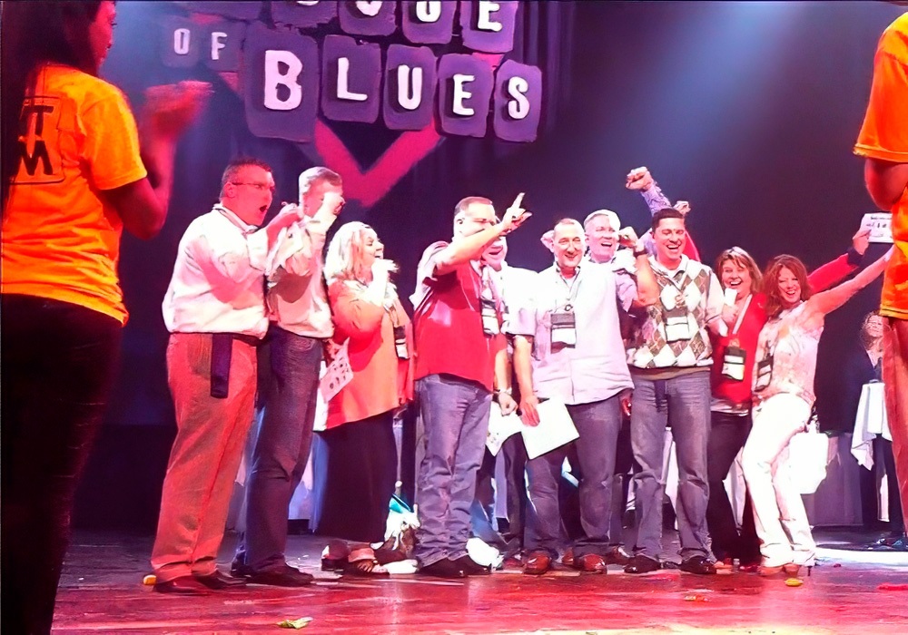 A group of people posing on stage.