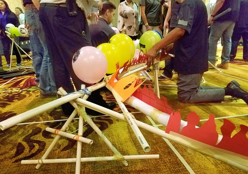 A group of people are making a dragon out of balloons.