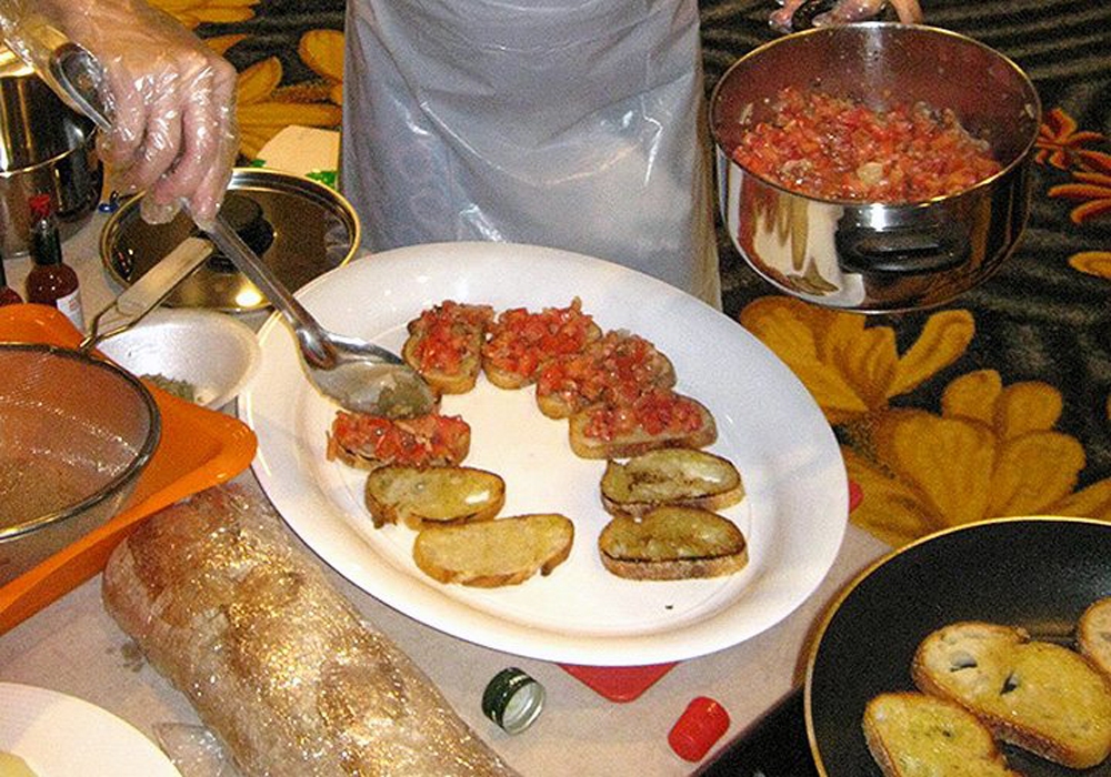 A woman is preparing food on a table.