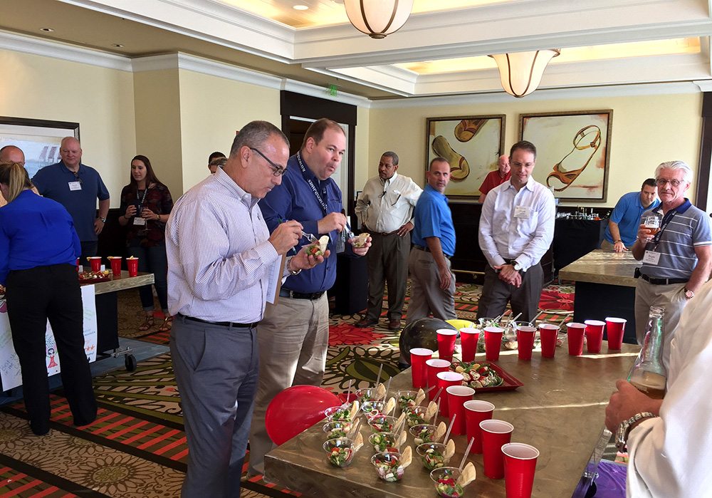 A group of people standing around a table.