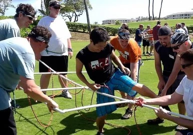 A group of people playing a game of tug of war.