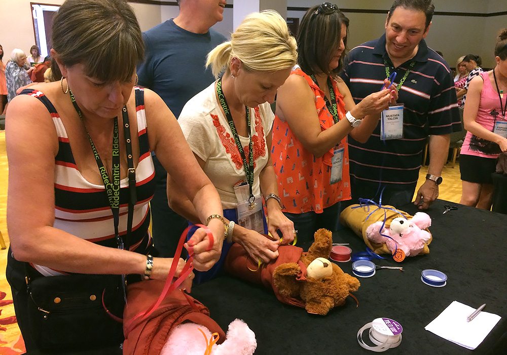 A group of people working on a teddy bear.