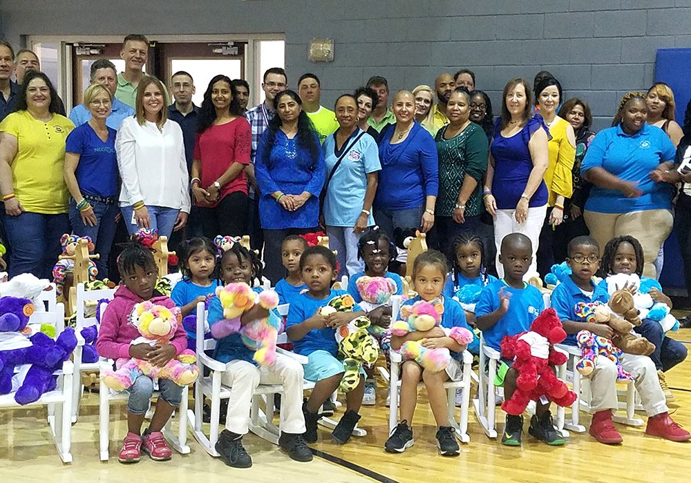 A group of children posing for a photo with teddy bears.