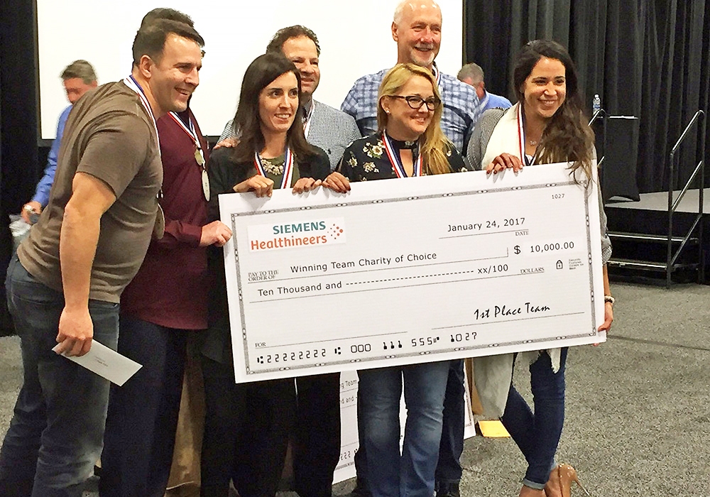 A group of people posing with a large check.