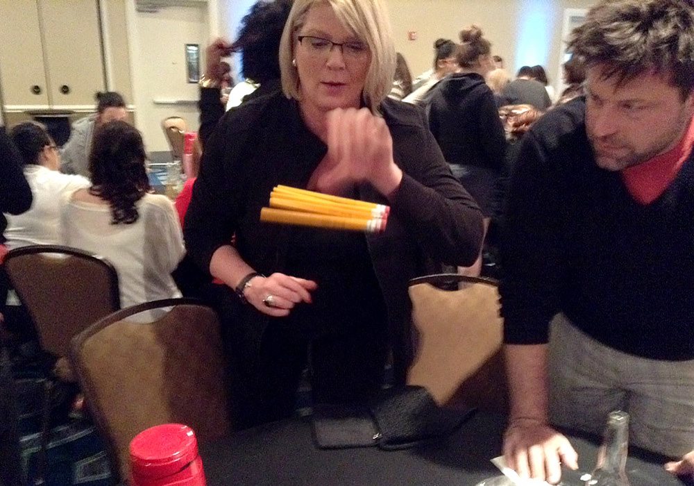A man and a woman standing around a table.