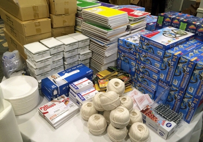 A table full of school supplies on a table.