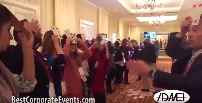 A group of people holding up cards in a room.