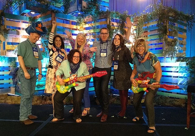A group of people posing for a picture on stage.