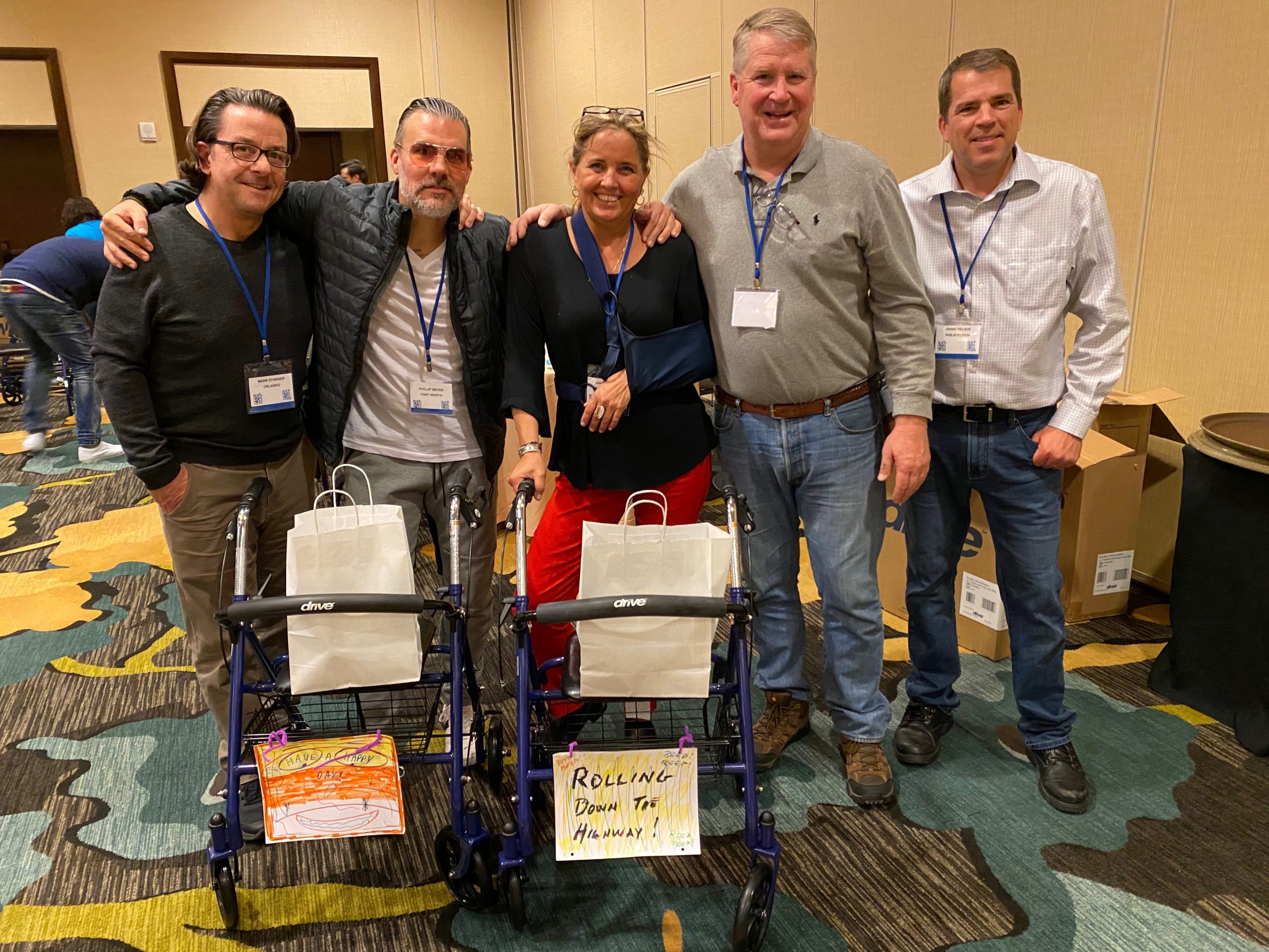 A group of people posing for a photo in a conference room.