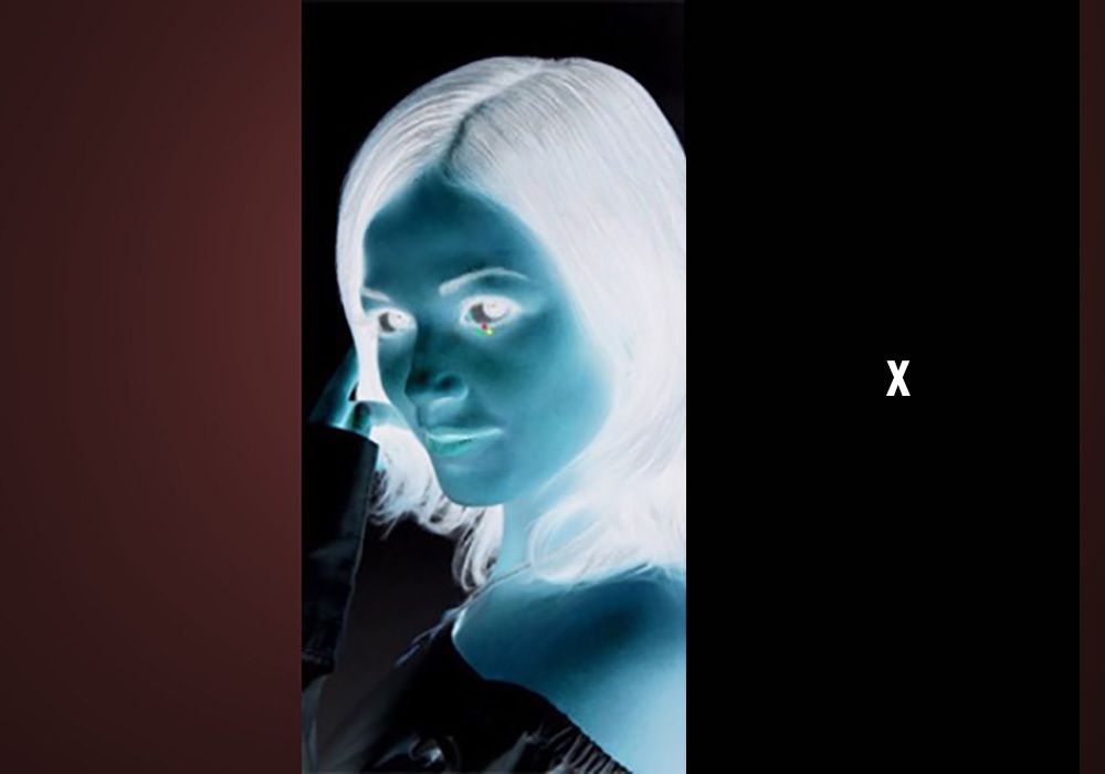 An image of a woman with white hair and blue eyes.