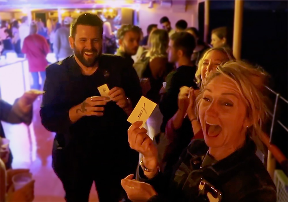 A group of people on a boat laughing at a party.