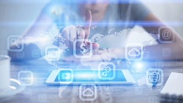 A woman is pointing at a tablet with a world map on it.