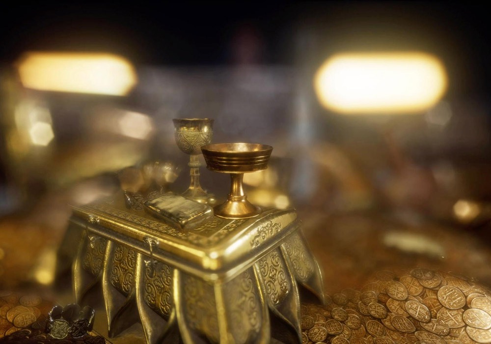 A small gold box with coins on top of it.