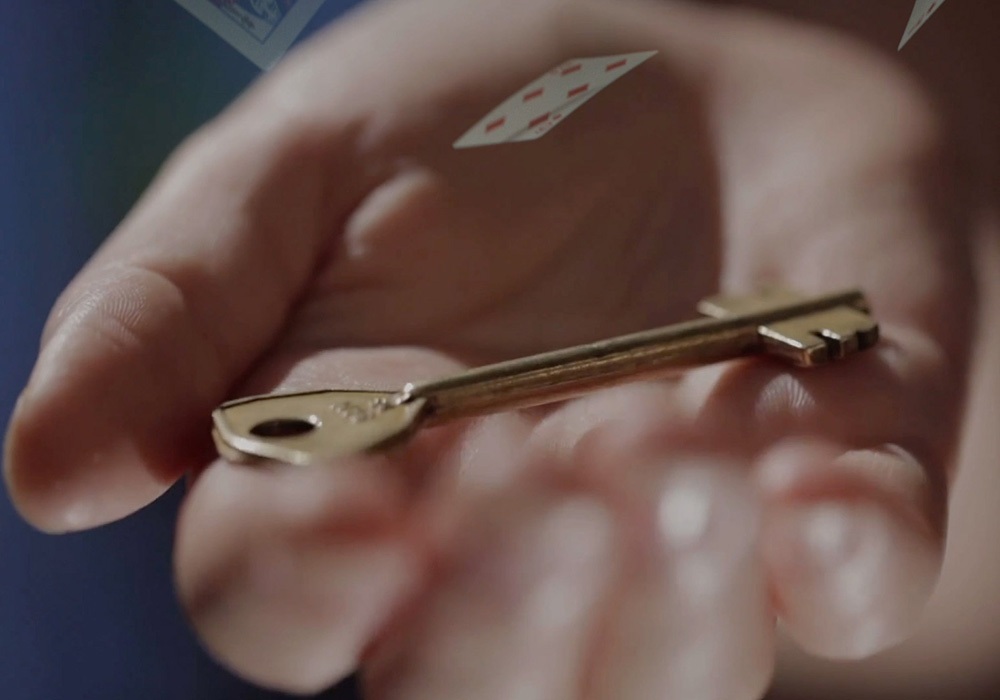 A person holding a key in their hand.