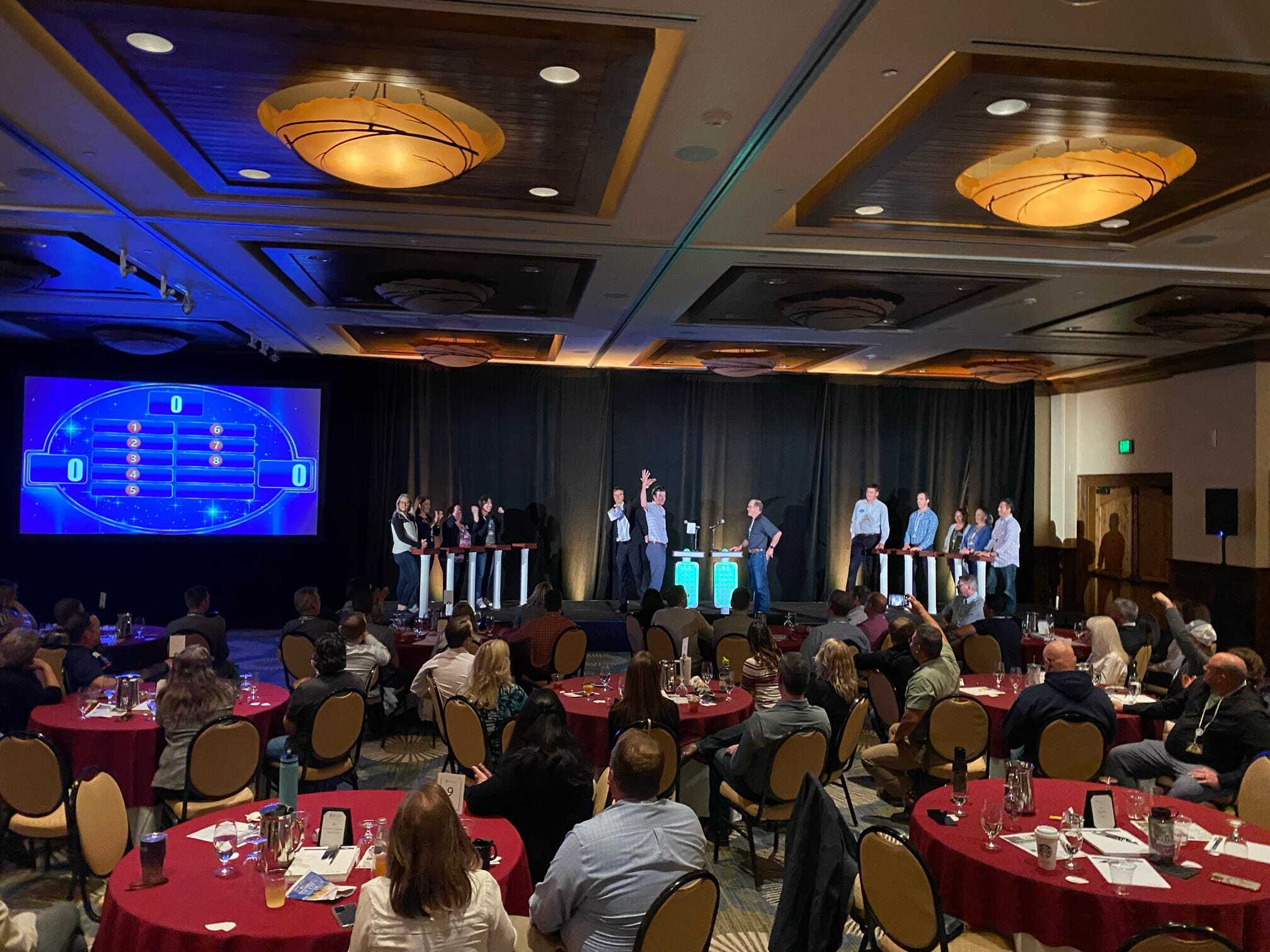 A group of people sitting at tables in a large room.