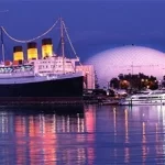 A large ship docked in the water at night.