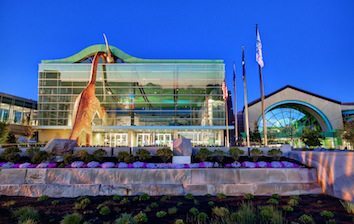 A building with a large glass facade at dusk.