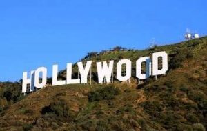 The hollywood sign is on top of a hill.