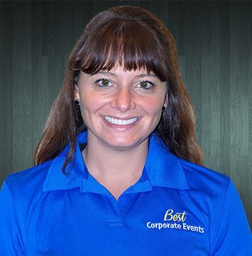 A woman in a blue shirt smiling at the camera.
