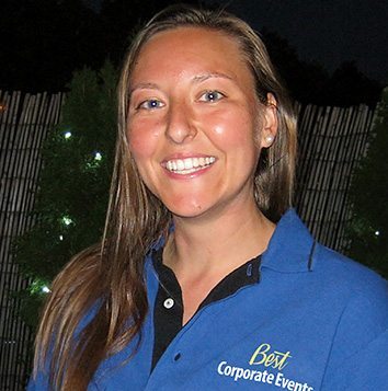 A woman wearing a blue polo shirt.