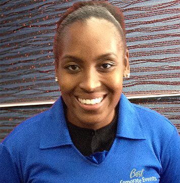 A woman in a blue shirt smiling for the camera.