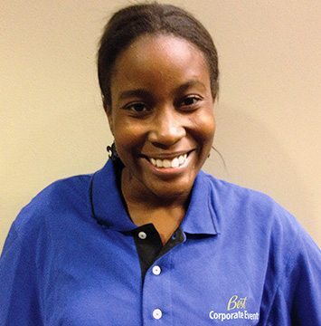 A smiling woman in a blue polo shirt.