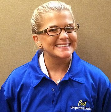 A woman wearing a blue shirt and glasses.