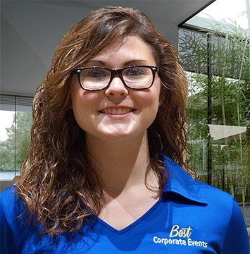 A woman wearing a blue shirt and glasses.