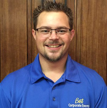 A man wearing a blue shirt and glasses.