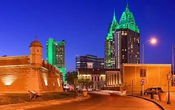 A city at night with a green wall in the background.