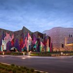 A building with a colorful facade at dusk.