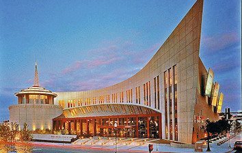 A building with a curved roof at dusk.
