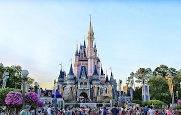 Cinderella's castle in front of a crowd of people.