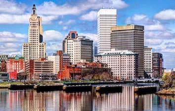 The skyline of a city with a river in the background.