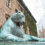 A statue of a tiger in front of a building.