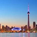 Team building activity in Toronto with the sparkling skyline at dusk and the iconic CN Tower as a breathtaking background.