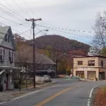 Wassaic team building takes place on a street in a small town, with a mountain in the background.