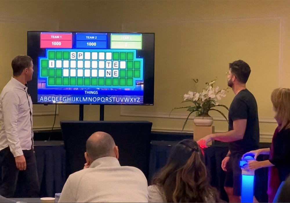 A group of people in front of a tv playing a game.