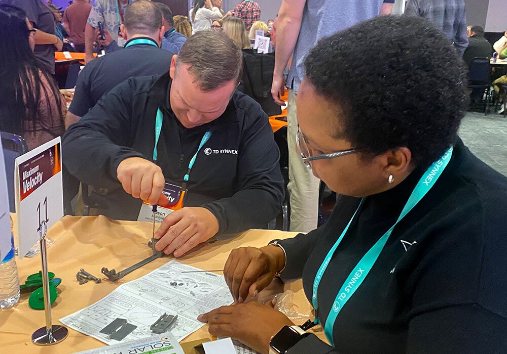 Two people working at a table.