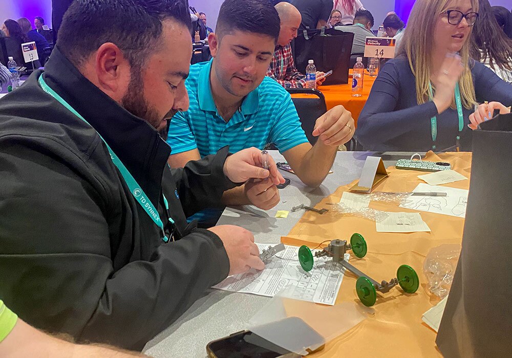 A group of people at a table working on a project.