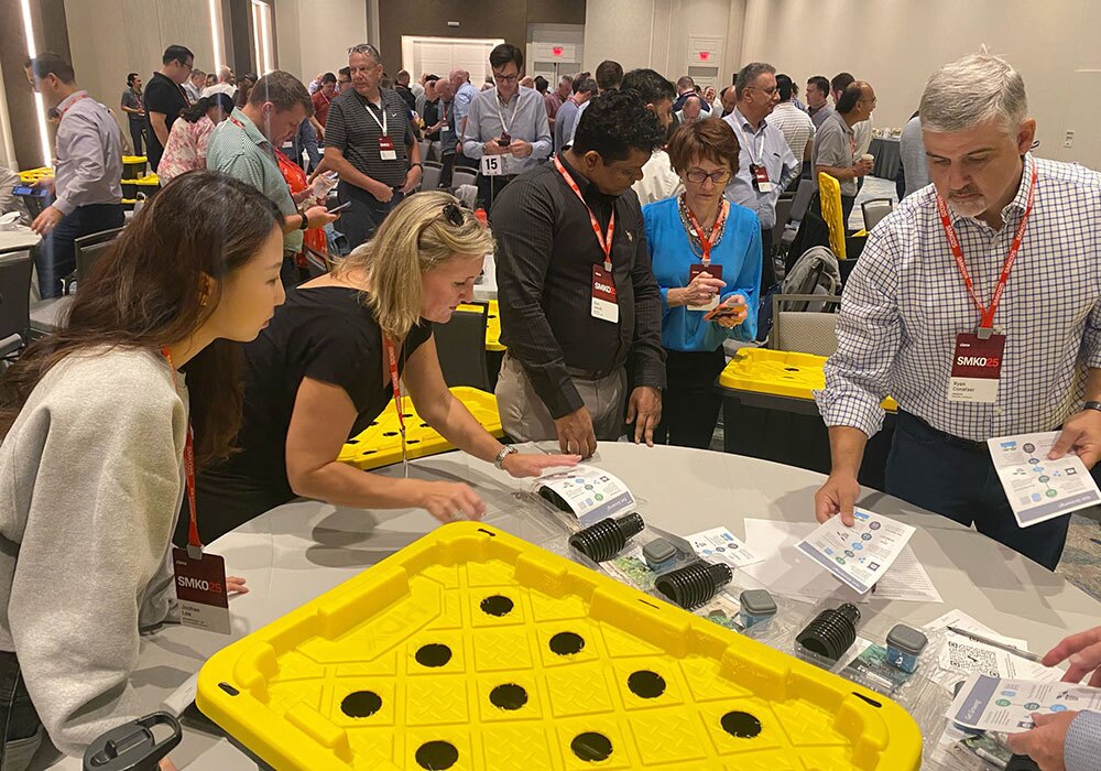 At the conference, people gathered around a table, delving into devices and papers on hydroponics. A sense of shared purpose was palpable as they discussed innovative solutions made possible through generous donations.