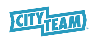 Logo with the word "City" in bold white letters and "Team" in bold blue letters. The text is framed by a blue outline forming a stylized angular shape around the words.