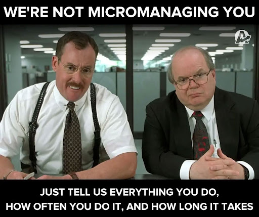 Two men in suits sit at a desk in an office with a caption above and below them about not micromanaging but asking for detailed work updates.